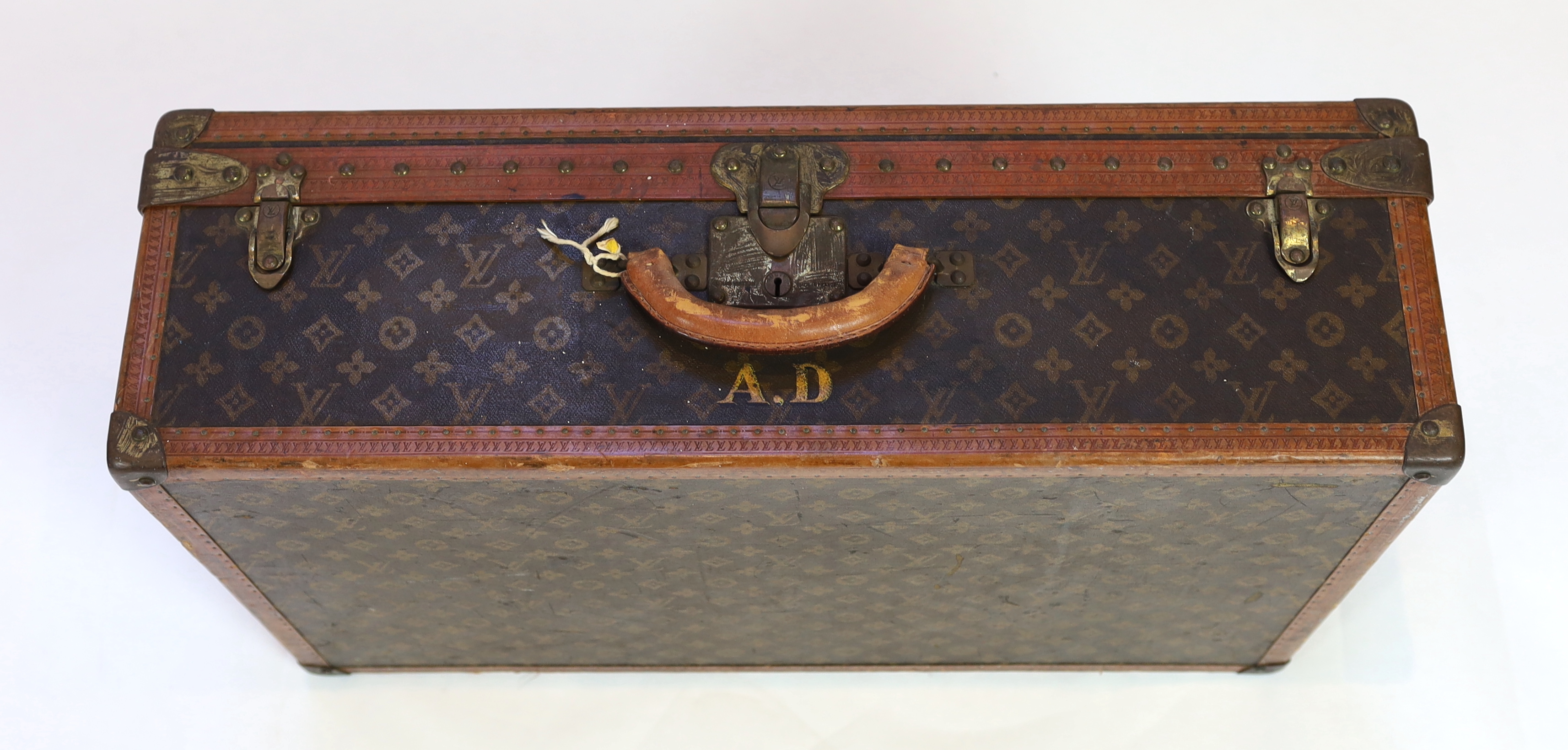A vintage Louis Vuitton suitcase with monogram canvas and tan leather, width 71cm, height 44cm, depth 22cm